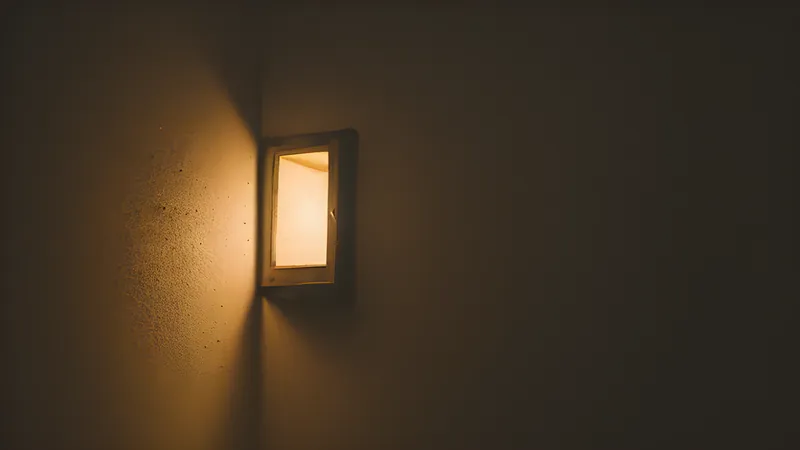 A glowing service hatch in a wall passing small requests through in exchange for small glowing replies, warm orange accent lighting